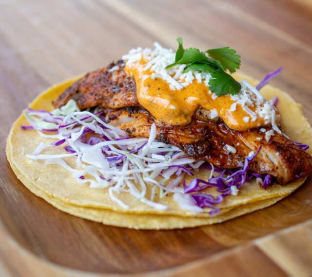 Corn tortillas topped with cabbage, blackened pollock, tangy Louisiana-style remoulade, cotija cheese, and cilantro.